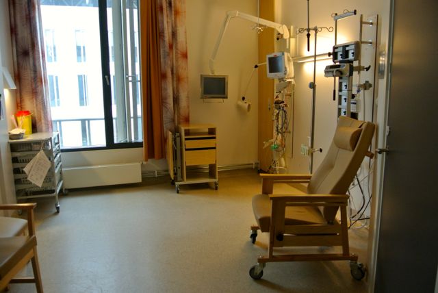 Hospital room with state-of-the-art headwall. The patient on a gurney is simply rolled into place. They need the CARE Channel.