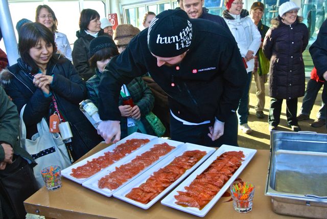 A ship chef adds aquavit to fresh salmon sashimi, just sliced from a whole freshly caught salmon, and served to all on deck.